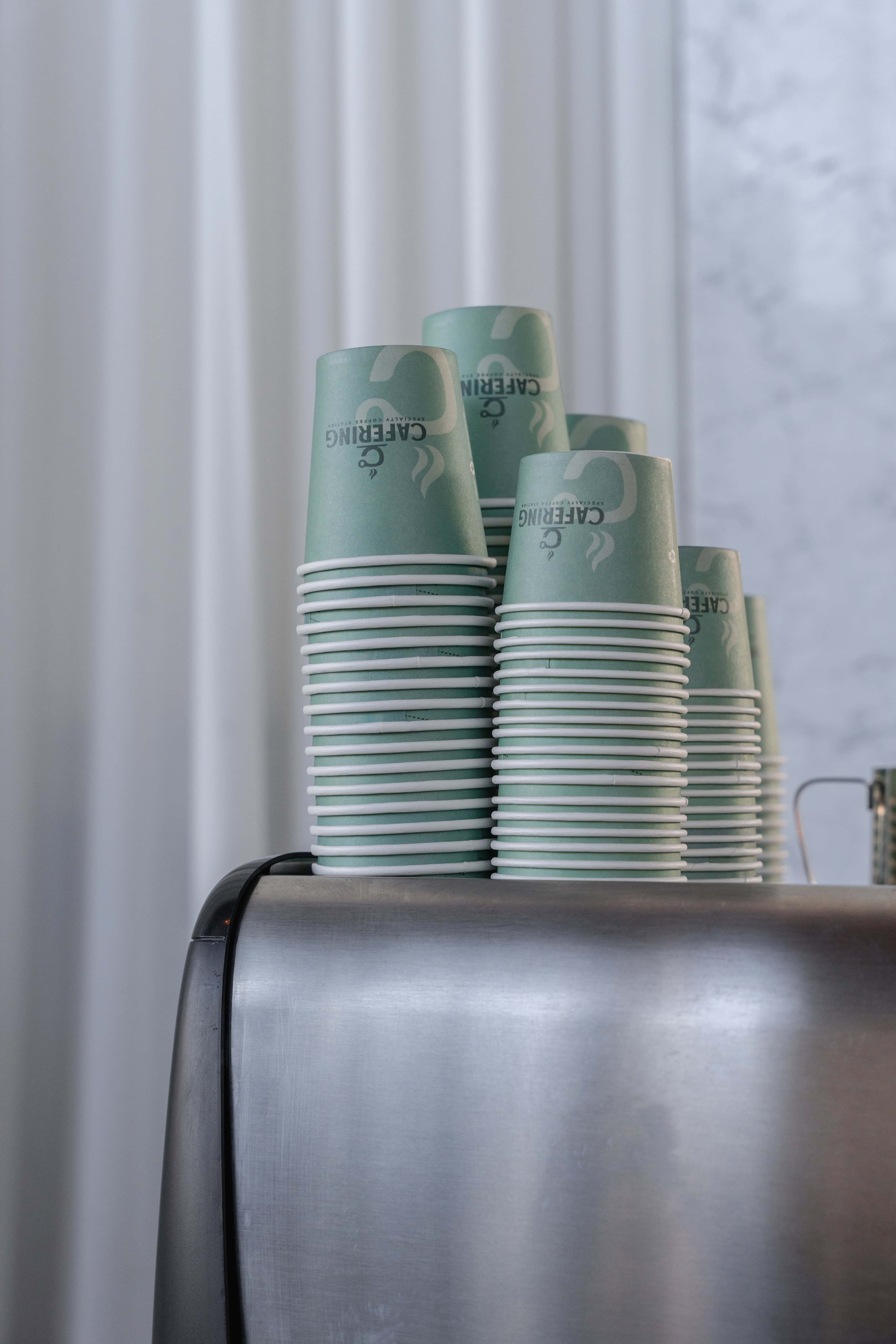 Cafering branded cups on top of an espresso machine