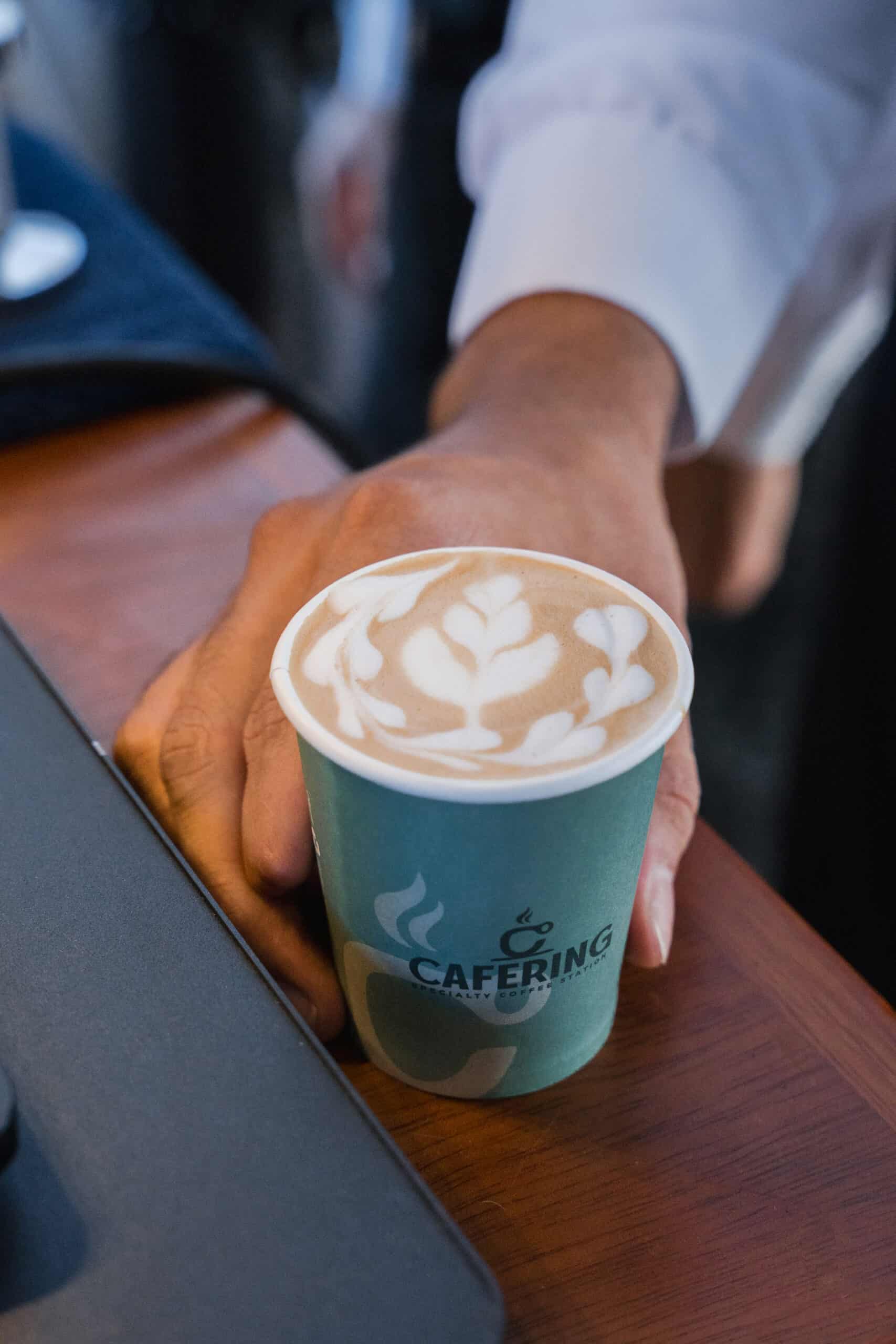 Latte art poured at a wedding coffee cart