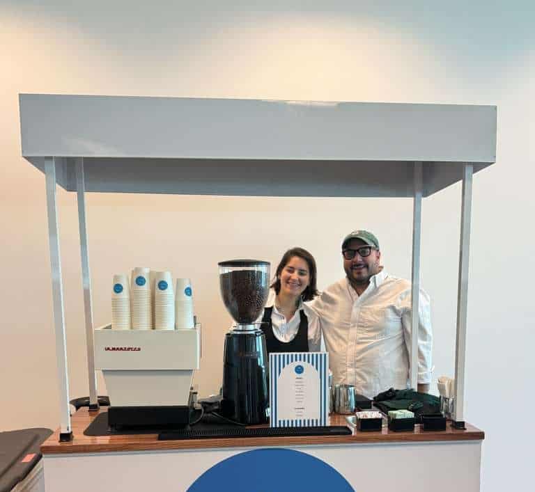 Full mobile coffee bar setup with espresso machine, cups, and barista station at an outdoor event