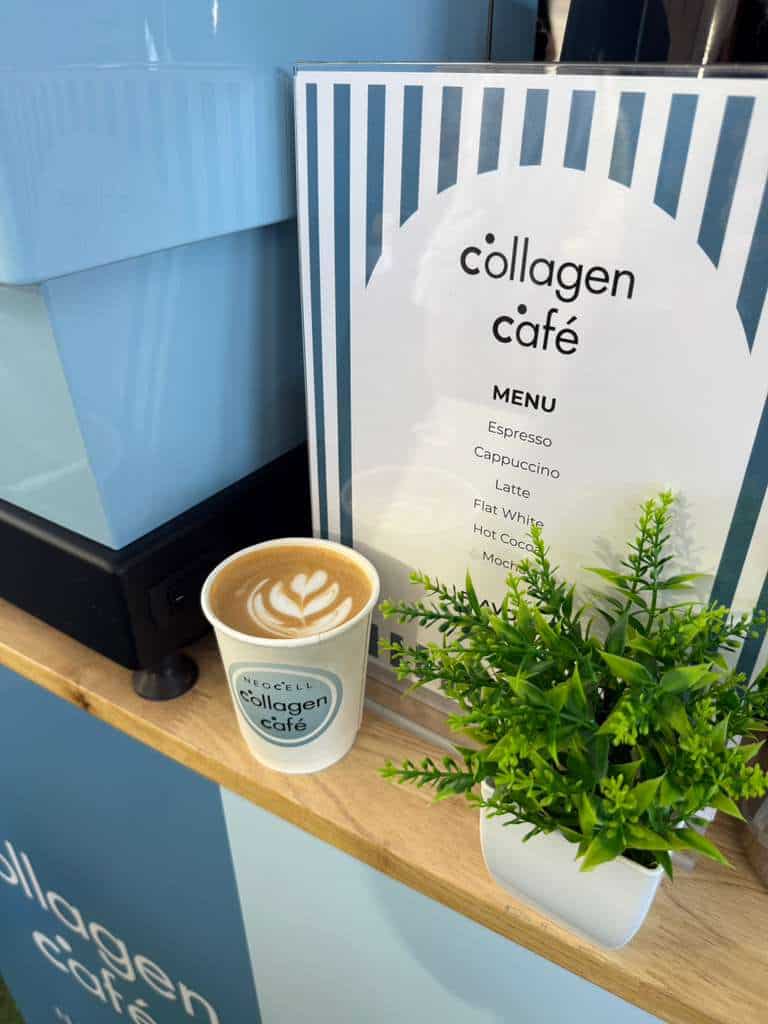 Attendees gathered near a coffee cart at a trade show booth
