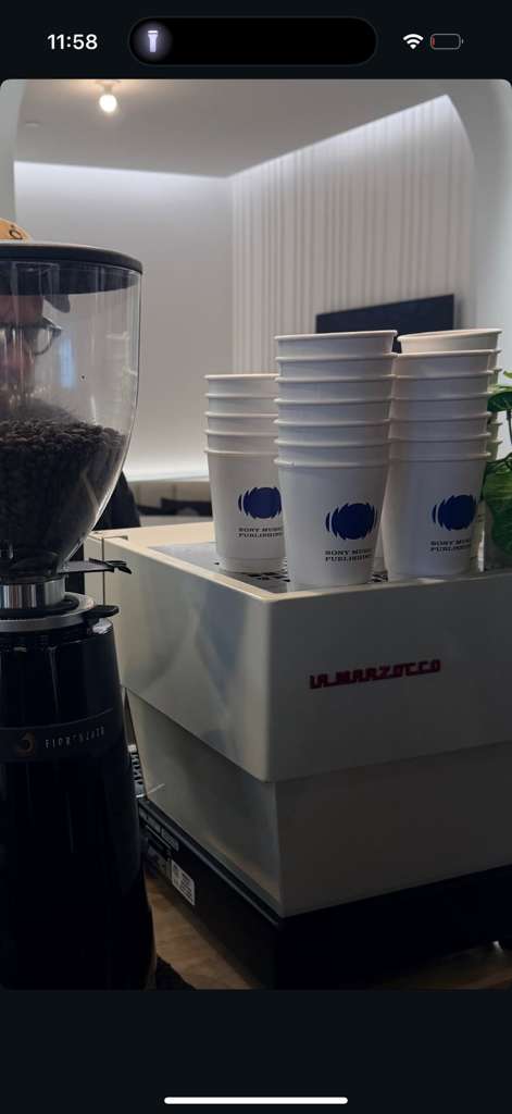 Custom branded coffee cups and sleeves at a Miami event