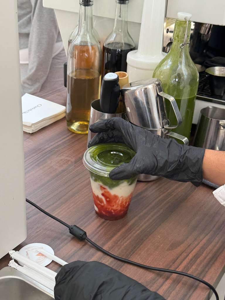 Barista preparing a strawberry matcha latte at a Charlotte Tilbury event in Miami