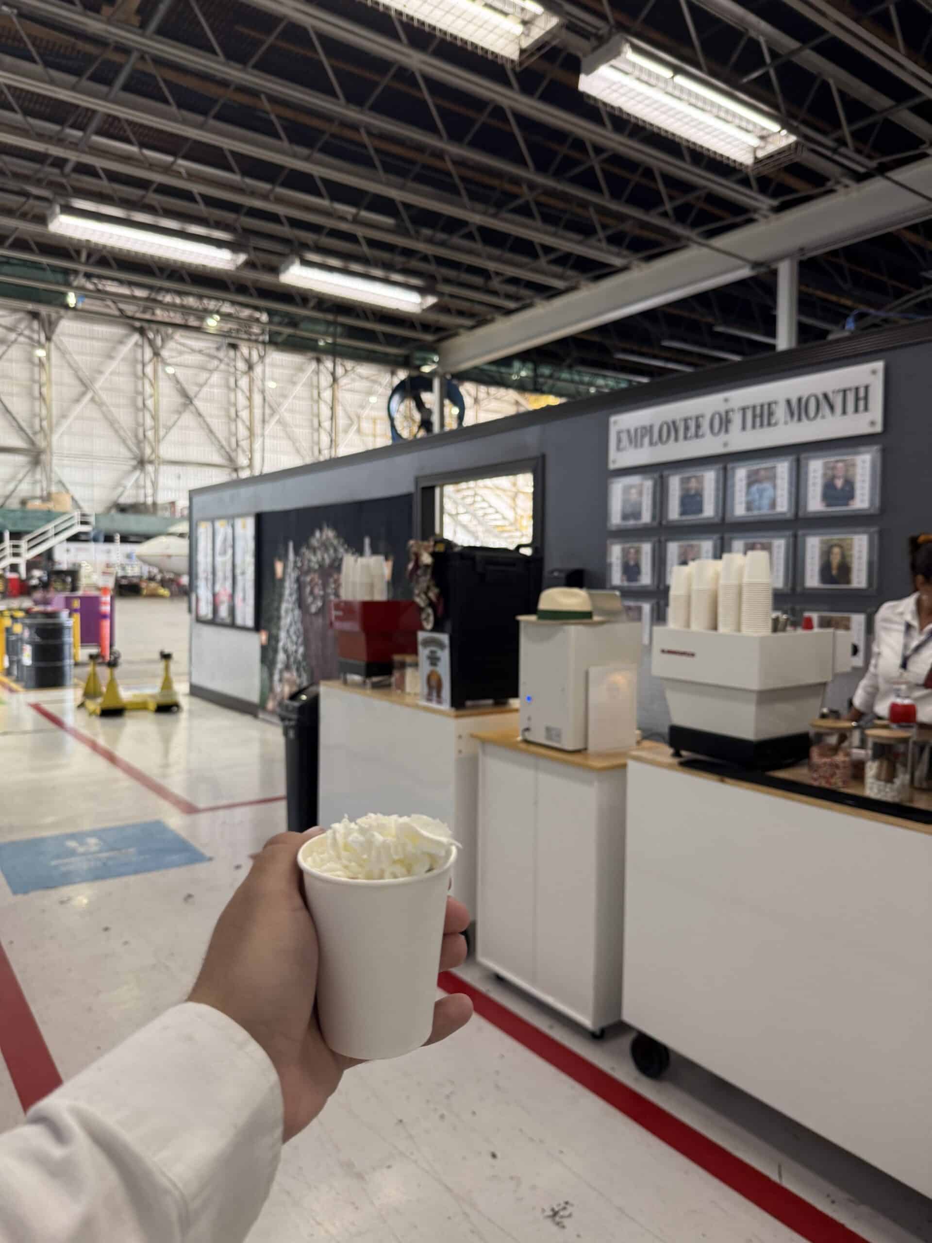 Double hot chocolate cart setup for AAR Corp employee appreciation event in an airport hangar
