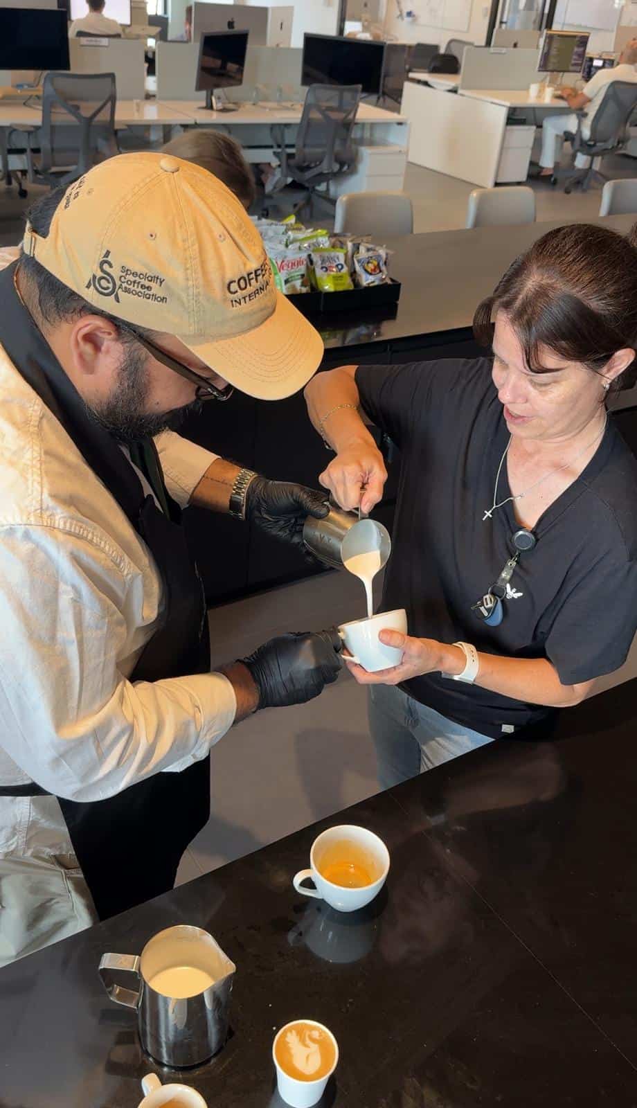 Cafering barista running a latte art demo for IRU, formerly Kandji, employees in Coral Gables