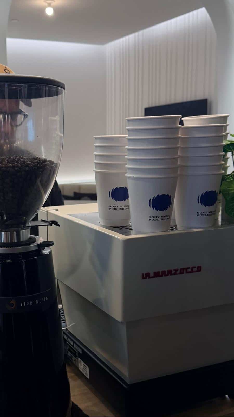 Sony branded cups on top of a La Marzocco espresso machine