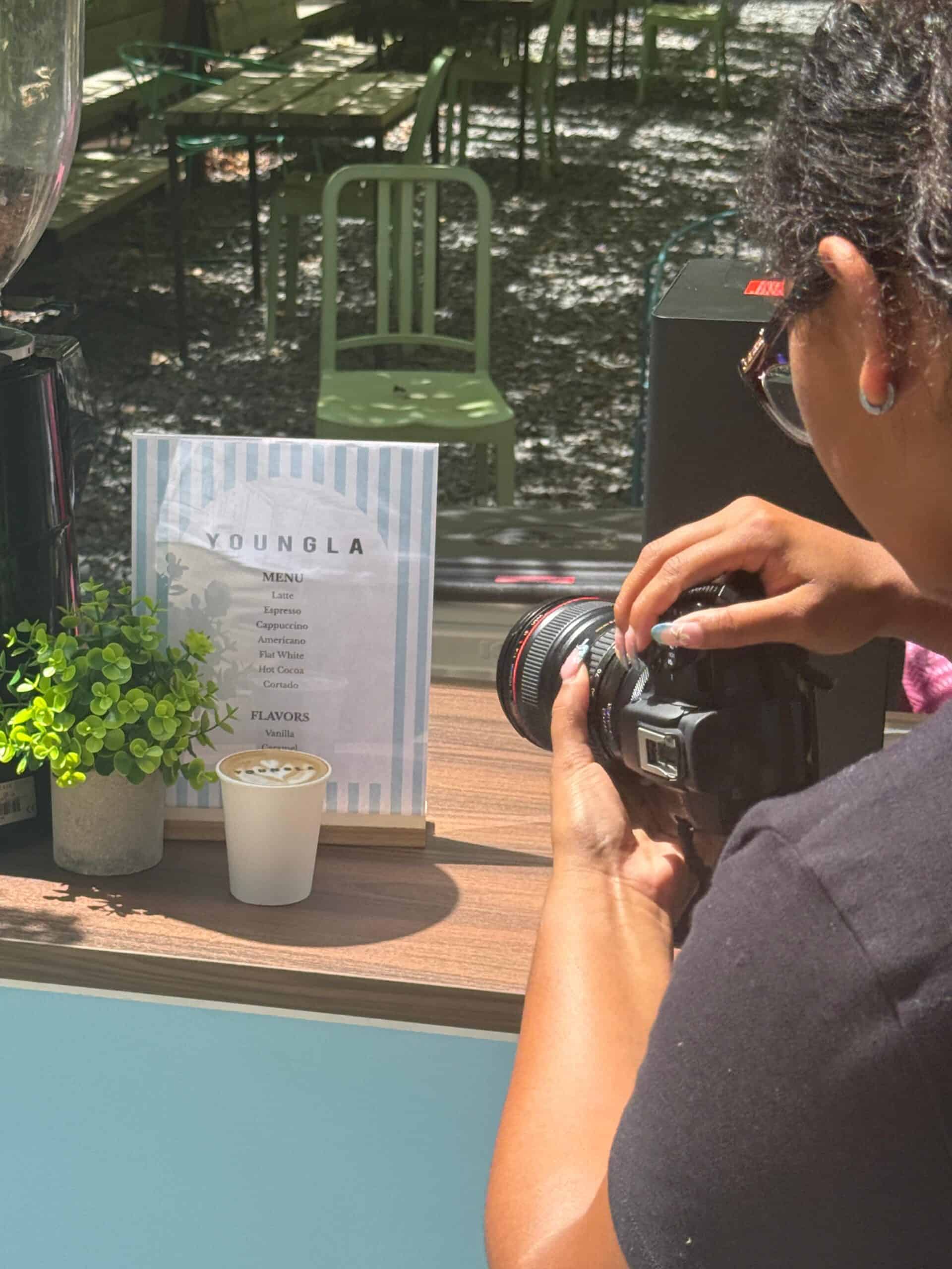 Guest photographing the branded YoungLA coffee cart for social media